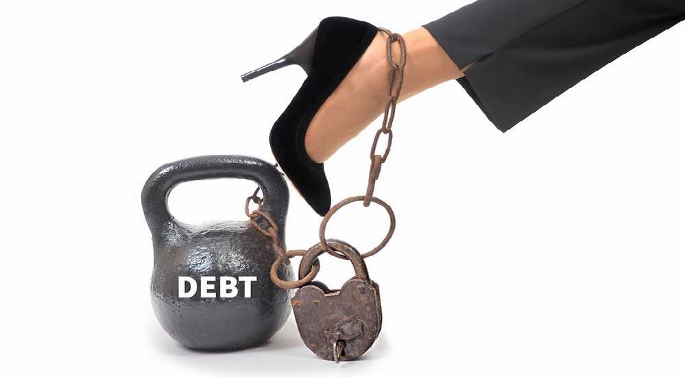 How to Pay Off Debt Fast on a Low Income: A woman's leg is chained to a kettlebell, highlighting the struggle of paying off debt fast on a low income.